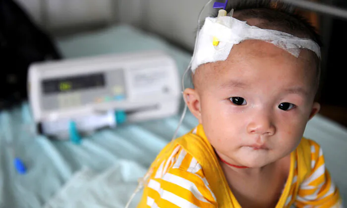 A baby who suffers from kidney stones after drinking tainted milk powder, gets IV treatment at the Chengdu Children's Hospital in China's Sichuan Province, on Sept. 22, 2008. (China Photos/Getty Images)