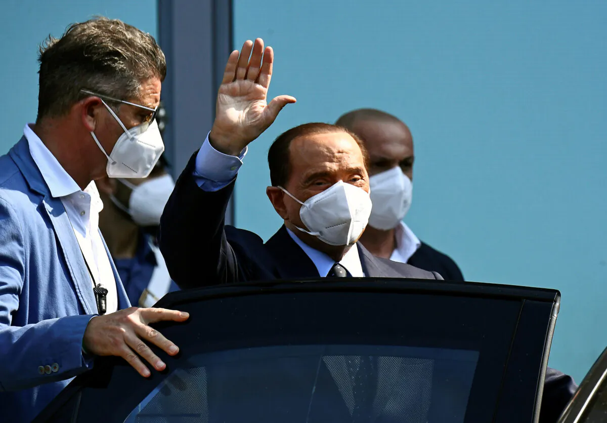 Former Italian Prime Minister Silvio Berlusconi gestures as he is discharged from Milan's San Raffaele hospital, where he was being treated after testing positive for the coronavirus disease (COVID-19) and diagnosed with mild pneumonia, in Milan, Italy, on Sept. 14, 2020. (Flavio Lo Scalzo/Reuters)