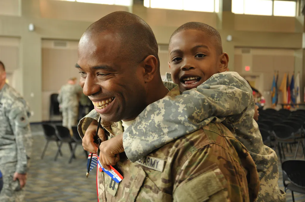 Georgia Army National Guard Capt. Chad Tyson receives a hug from son Chase during a welcome home ceremony in Marietta, Ga., after a 10-month deployment to Afghanistan, on Nov. 22, 2013. (Courtesy of the National Guard Flickr page)
