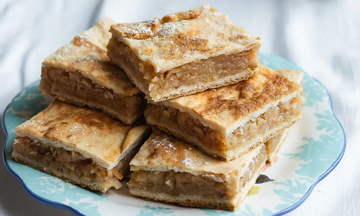 Placinte come with a variety of doughs and fillings, both savory and sweet, but perhaps most beloved of all is placinta cu mere: made with grated, spiced, and stewed apples, and a soft dough enriched with sour cream. (Irina Georgescu)