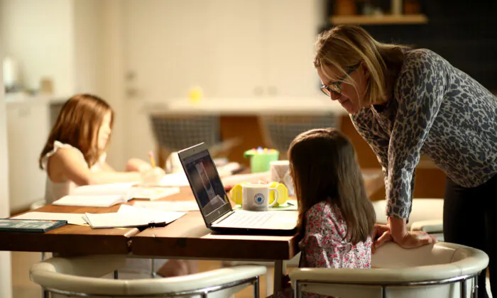 Daisley Kramer helps her kindergarten daughter, Meg, with schoolwork at home in San Anselmo, Calif., on March 18, 2020. (Ezra Shaw/Getty Images)