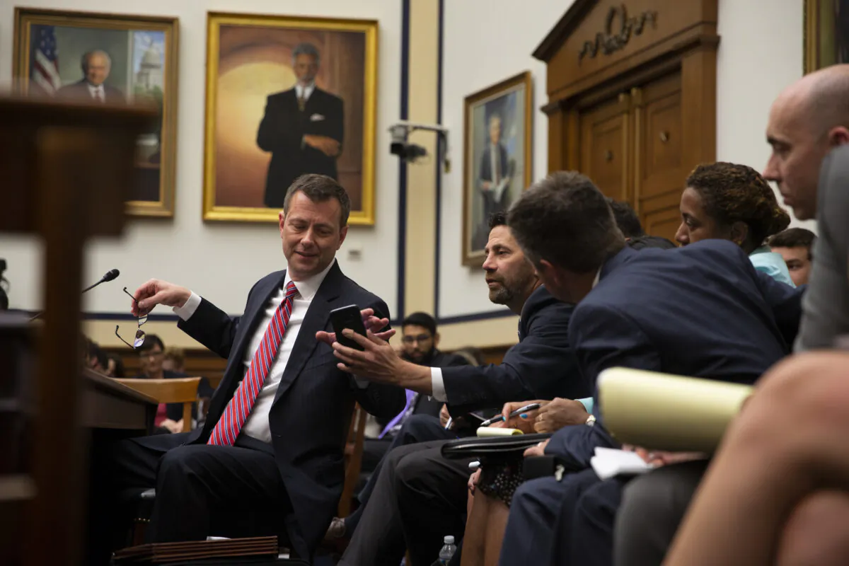 Then-FBI official Peter Strzok confers with his legal counsel before a joint committee hearing on Capitol Hill in Washington on July 12, 2018.   Alex Edelman/Getty Images