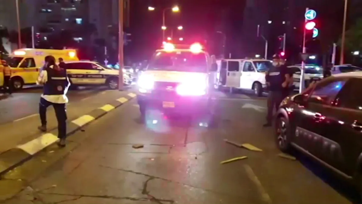 Israelis and Israeli police cars are seen in a street after a rocket from Gaza hit the city of Ashdod, Israel, on Sept. 15, 2020. (Screenshot/MDA Handout via Reuters)