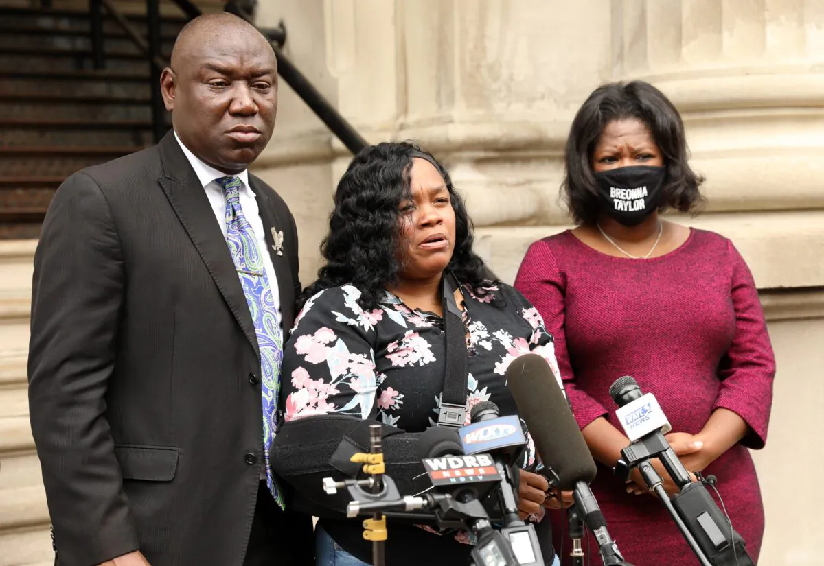 Breonna Taylor's mother Tamika Palmer, center, addresses the media over the speed of the investigation of her daughter's death as attorney Benjamin Crump, left, and co-counsel Lonita Baker look on outside Louisville City Hall in Louisville, Ky., on Aug. 13, 2020. (John Sommers II/Getty Images)