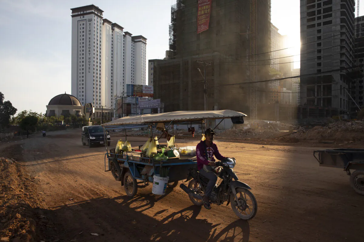 A Cambodian motorcycle cart drives down a dirt road in Sihanoukville, Cambodia, on Feb. 16, 2020. (Paula Bronstein/Getty Images )