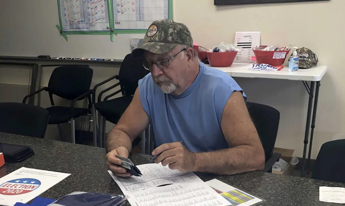 Ken Miller fills out the state election form to change his voter registration from Democrat to Republican. (Salena Zito)
