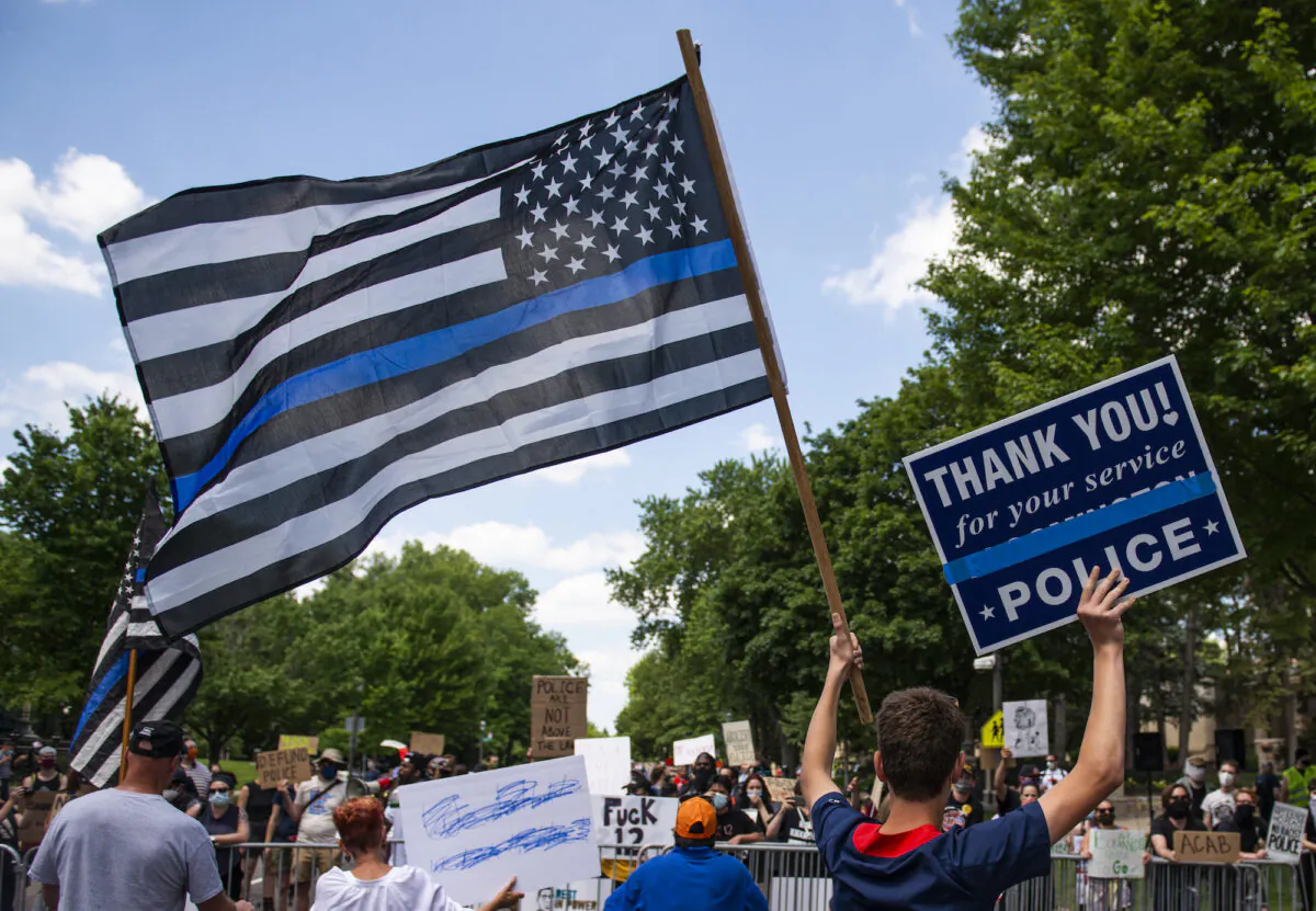 A demonstrator holds a "Thin Blue Line" flag in support of law enforcement, at a protest in St Paul, Minn., on June 27, 2020. (Stephen Maturen/Getty Images)