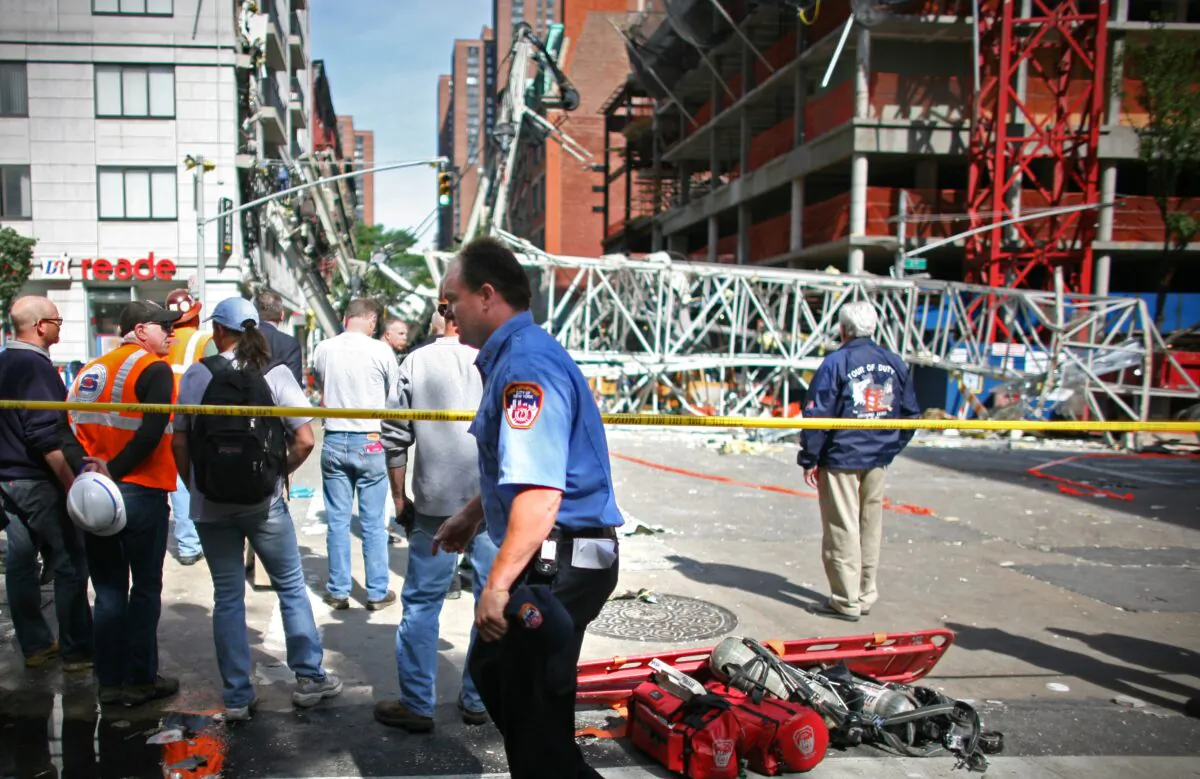 In this file photo, construction workers observe the scene of a crane collapse on Manhattan's Upper East Side at 91st Street and 1st Avenue May 30, 2008 in New York. (Yana Paskova/Getty Images)