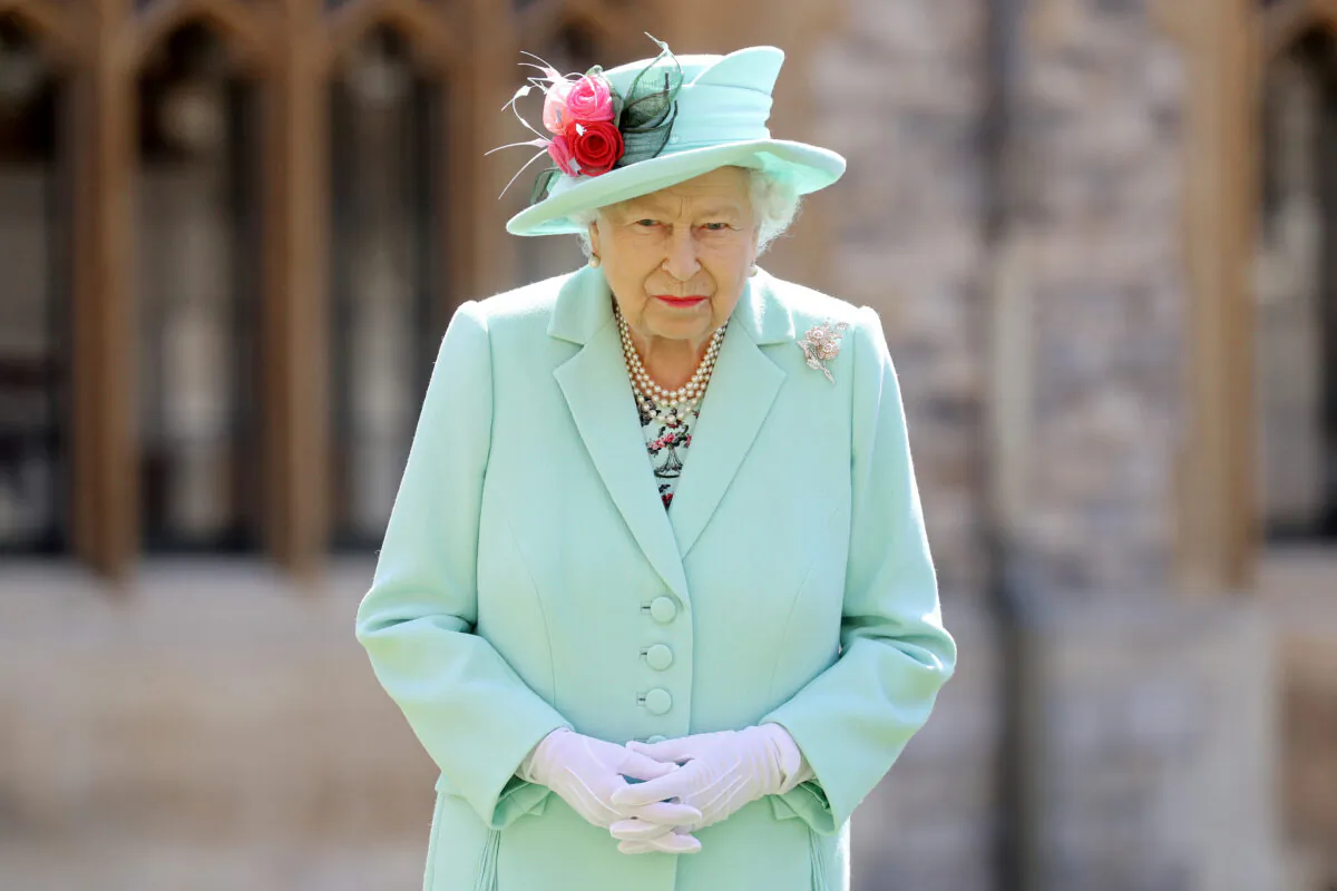Britain's Queen Elizabeth poses after awarding Captain Tom Moore with the insignia of Knight Bachelor at Windsor Castle, on July 17, 2020. (Chris Jackson/Pool via Reuters/File Photo)