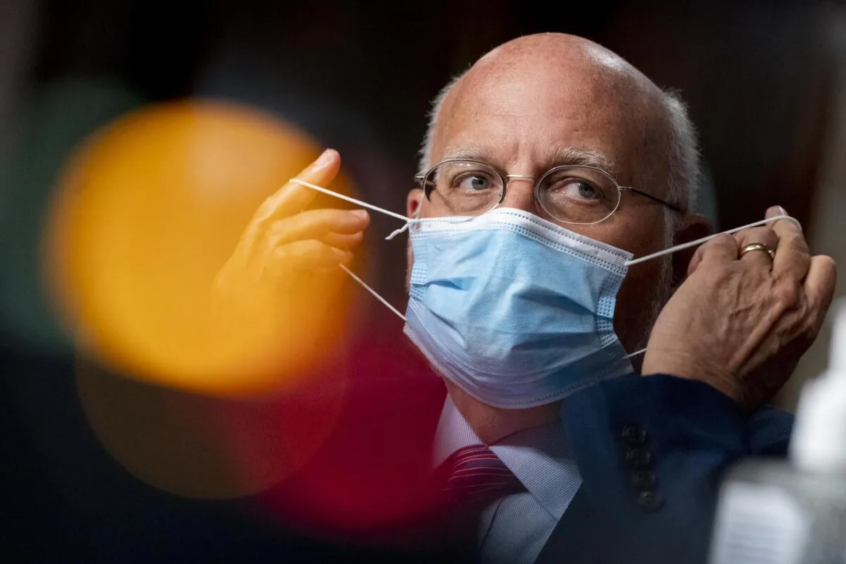 Centers for Disease Control and Prevention (CDC) Director Dr. Robert Redfield puts his mask on after speaking at a hearing of the Senate Appropriations subcommittee reviewing CCP virus response efforts in Washington, on Sept. 16, 2020. (Andrew Harnik-Pool/Getty Images)