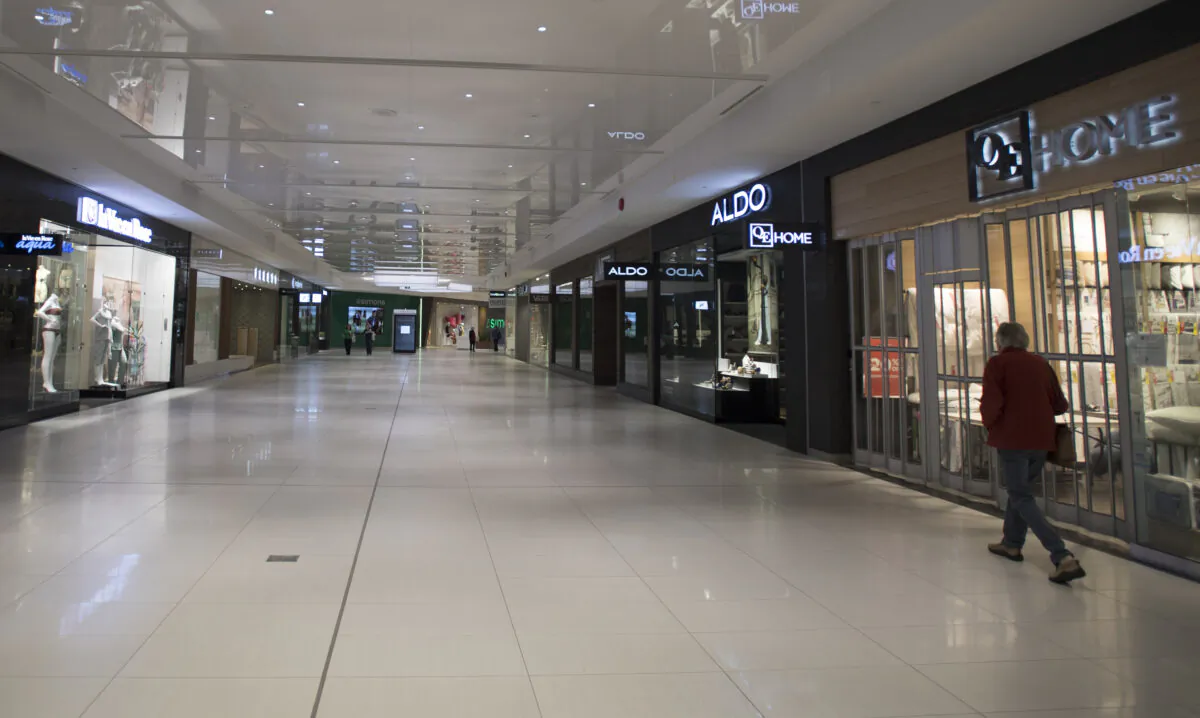 Stores are seen closed in a near-empty shopping mall in West Vancouver on May 13, 2020. Many of the stores are shut down due to the COVID-19 pandemic. (The Canadian Press/Jonathan Hayward)