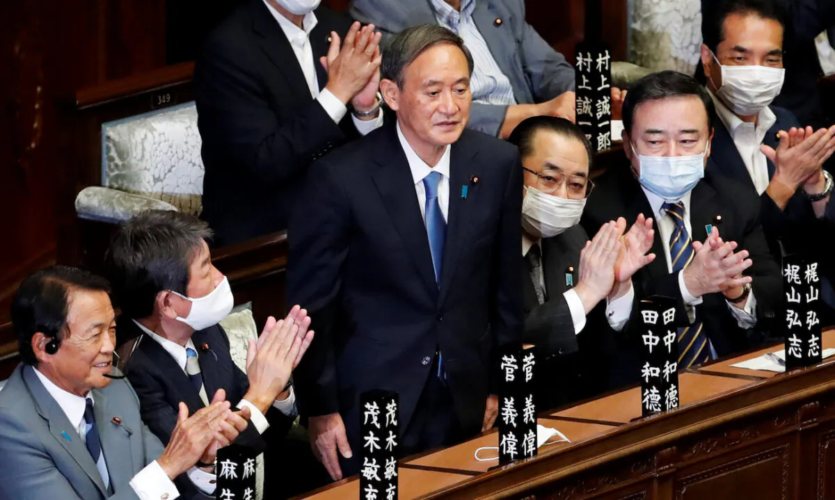 Japan's newly-elected Prime Minister Yoshihide Suga stands as he was chosen as new prime minister at the Lower House of Parliament in Tokyo, Japan, on Sept. 16, 2020. (Reuters/Kim Kyung-Hoon)