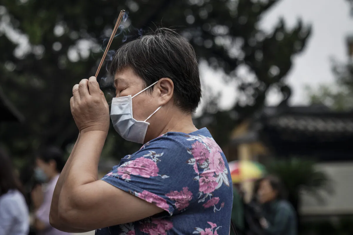A woman worships at the Guiyuan temple in Wuhan, central China’s Hubei Province on Sept. 16 , 2020. (Getty Images)