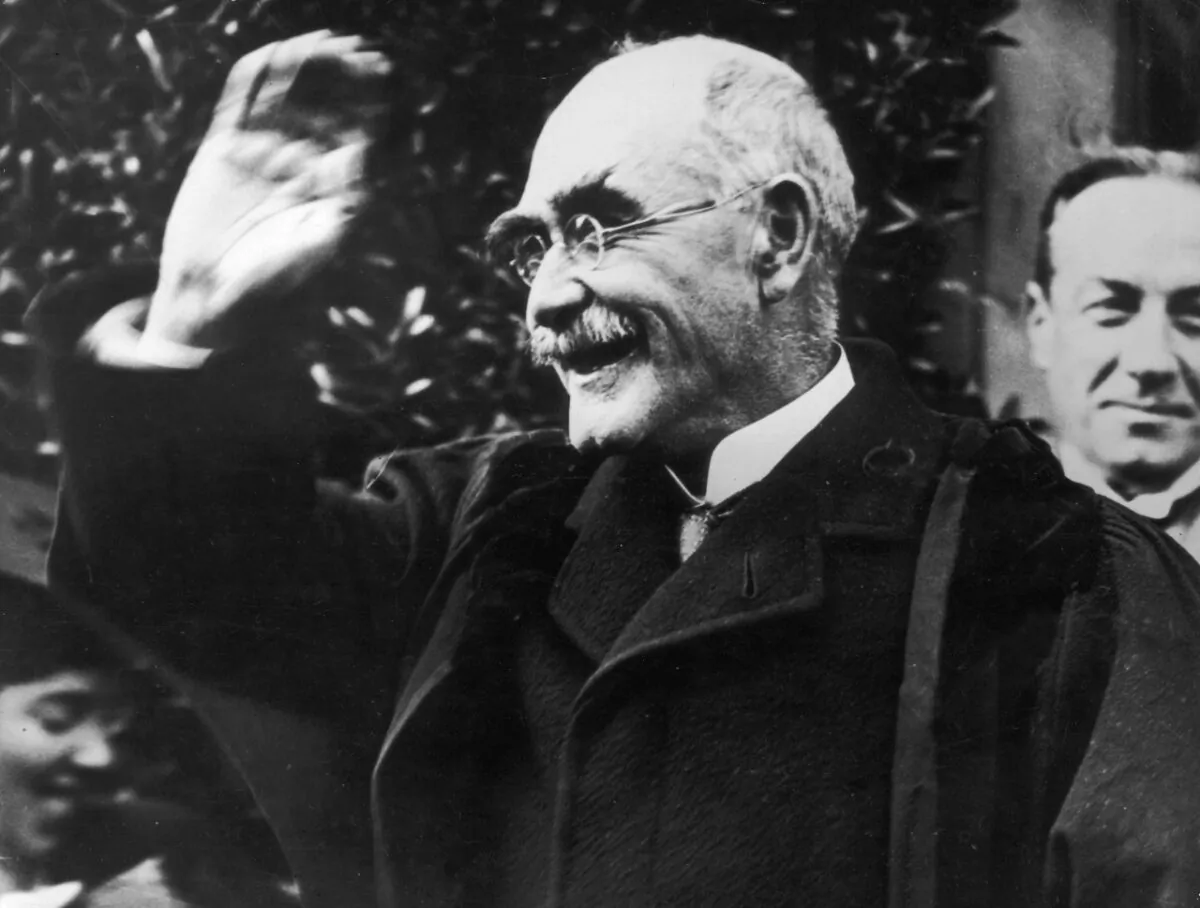 Author Rudyard Kipling (1865-1936) smiling in acknowledgment of his appointment as Rector of St Andrew's University in October 1923. British Prime Minister Stanley Baldwin (1867-1947) can be seen over his shoulder. (Topical Press Agency/Getty Images)