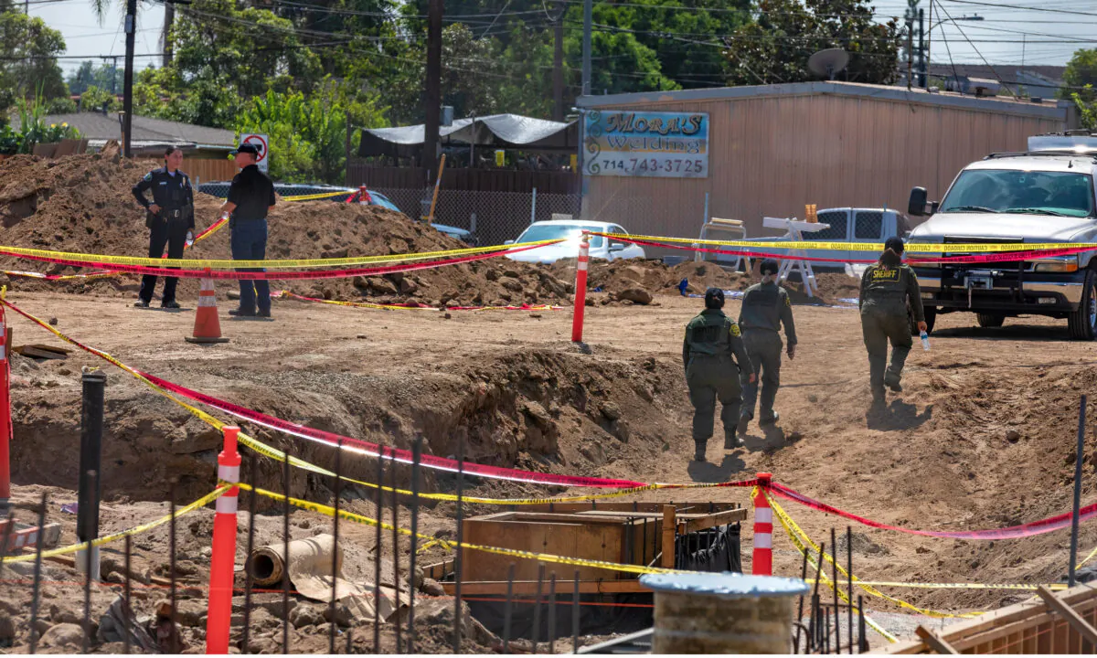 Detectives from the Santa Ana Police Department and the Orange County Sheriff's Department Coroner Division investigate the construction site where human bones were discovered in Santa Ana, Calif., on Sept. 17, 2020. (John Fredricks/The Epoch Times)