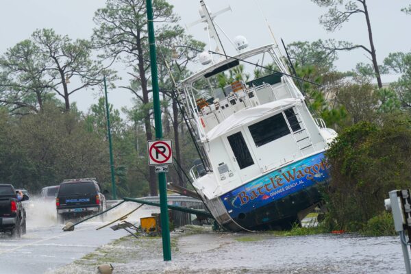 A boat is washed up near a road