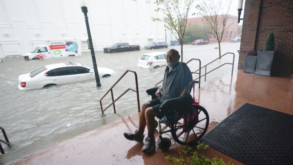 A man watches floodwaters