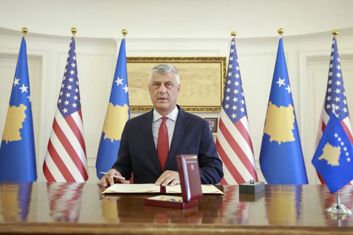 Kosovo's President Hashim Thaci signs the Order of Freedom awarded to U.S. President Donald Trump, in capital Pristina, on Sept. 18, 2020. (Visar Kryeziu/AP Photo)
