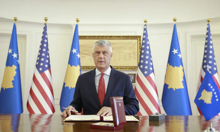 Kosovo's President Hashim Thaci signs the Order of Freedom awarded to U.S. President Donald Trump, in capital Pristina, on Sept. 18, 2020. (Visar Kryeziu/AP Photo)