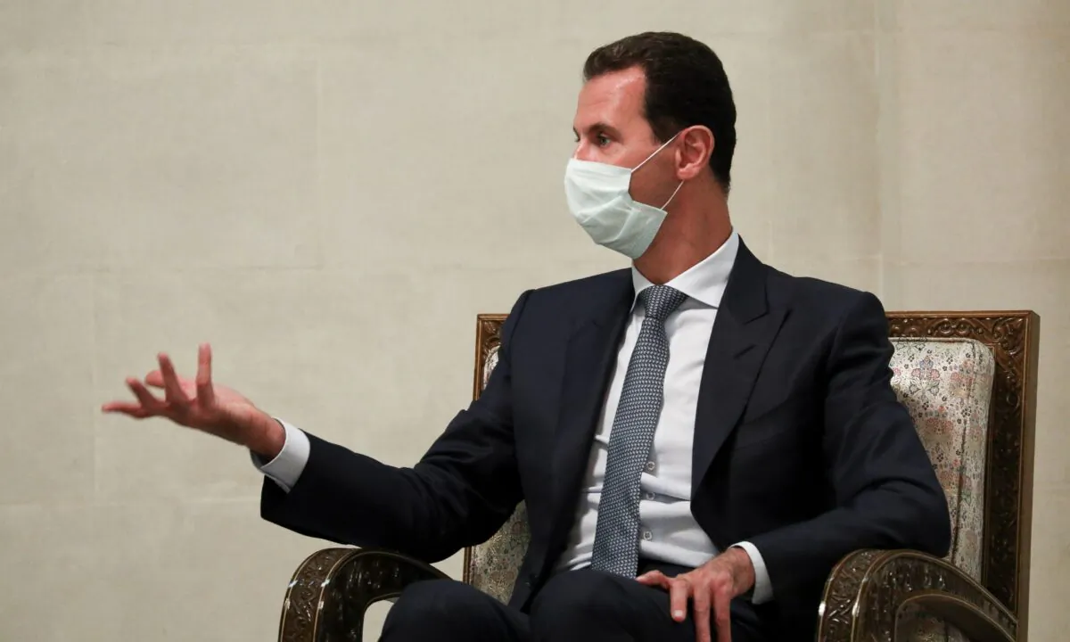 Syrian President Bashar al-Assad gestures while speaking to Russian Foreign Minister Sergey Lavrov during their talks in Damascus, on Sept. 7, 2020 (Russian Foreign Ministry Press Service via AP, File)