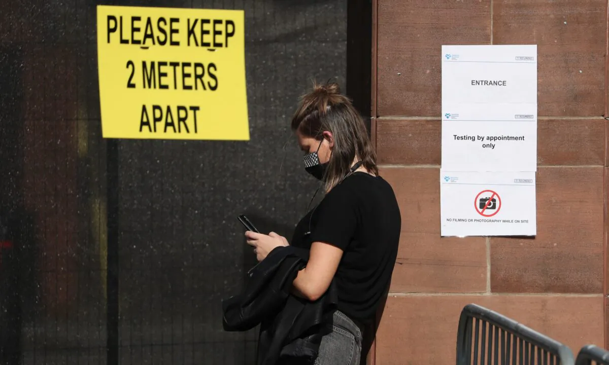 Members of the public queue outside the new walk-through testing centre as it opened today at Glasgow Caledonian University's ARC sports centre in Edinburgh, Scotland, on Sept. 18, 2020. (Andrew Milligan-WPA Pool/Getty Images)