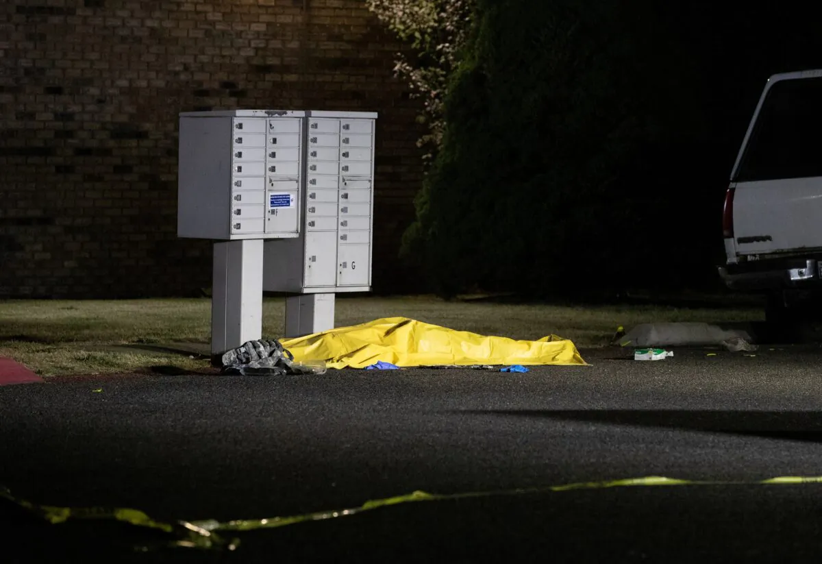A tarpaulin covers the body of Michael Forest Reinoehl, in Lacey, Wash., on Sept. 4, 2020. (Caitlin Ochs/Reuters)