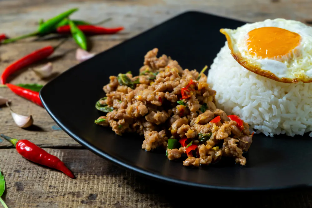 Serve pad krapow moo sap over rice, with an optional but recommended fried egg (khai dao). (Kritchai7752/Shutterstock)
