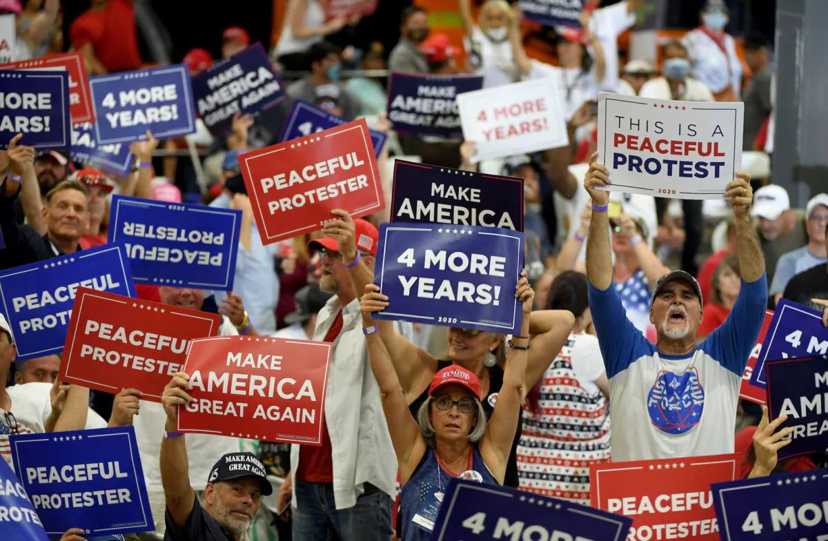 Supporters hold up signs during a campaign event for U.S. President Donald Trump at Xtreme Manufacturing in Henderson, Nev., on Sept. 13, 2020. (Ethan Miller/Getty Images)