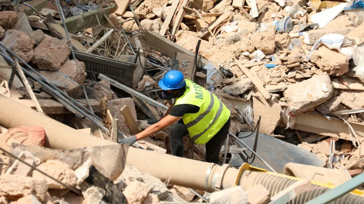 A volunteer digs through the rubble of buildings which collapsed due to the explosion at the port area, after signs of life were detected, in Gemmayze, Beirut, Lebanon, on Sept. 5, 2020. (Mohamed Azakir/Reuters, File Photo)