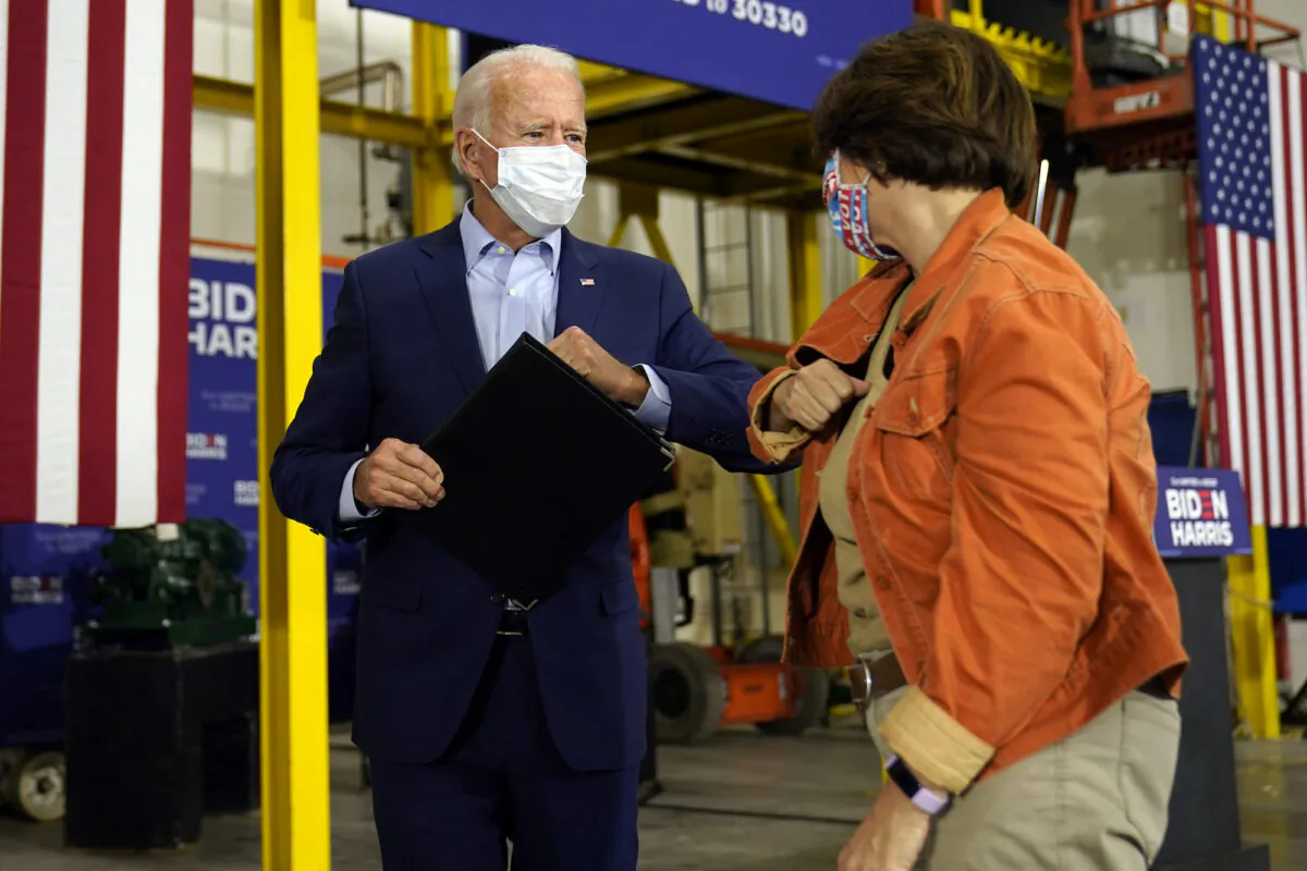 Democratic presidential candidate Joe Biden elbow bumps Sen. Amy Klobuchar, (D-Minn.) after he spoke at a union training center in Hermantown, Minn., on Sept. 18, 2020. (AP Photo/Carolyn Kaster)