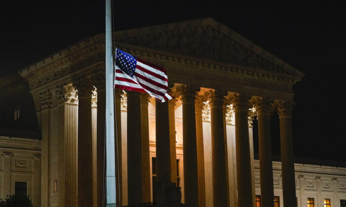 The American flag blows in the wind outside the Supreme Court building on Sept. 18, 2020. (Alex Brandon/AP Photo)