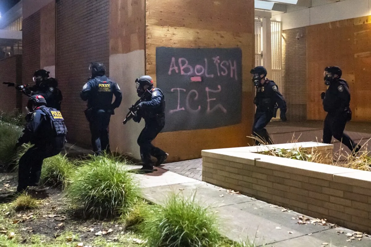Federal officers disperse a crowd at the Immigration and Customs Enforcement detention facility in Portland, Ore., on Sept. 18, 2020. (Nathan Howard/Getty Images)