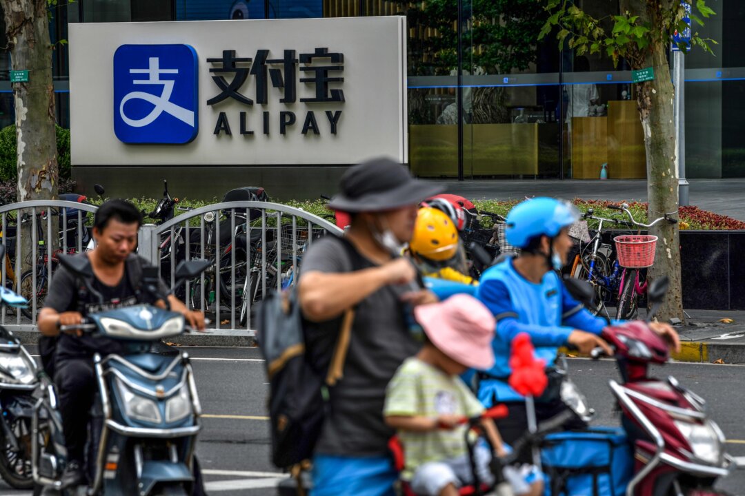 Motorists drive past an Alipay logo next to the Shanghai office building of Ant Group on Aug. 28, 2020. (HECTOR RETAMAL/AFP via Getty Images)