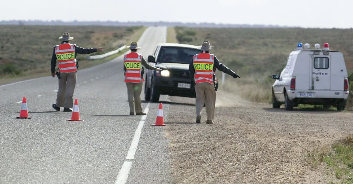 Police check cars at a road block north of Port Augusta, South Australia, on June 28, 2002. (ADELAIDE ADVERTISER/AFP via Getty Images)