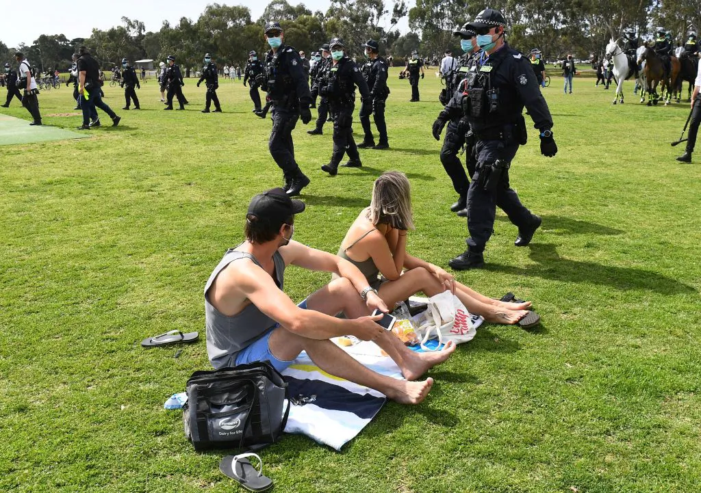 Police sweep through a park to break up an anti-lockdown protest in the Melbourne suburb of Elsternwick on Sept. 19, 2020. (William West/AFP via Getty Images)