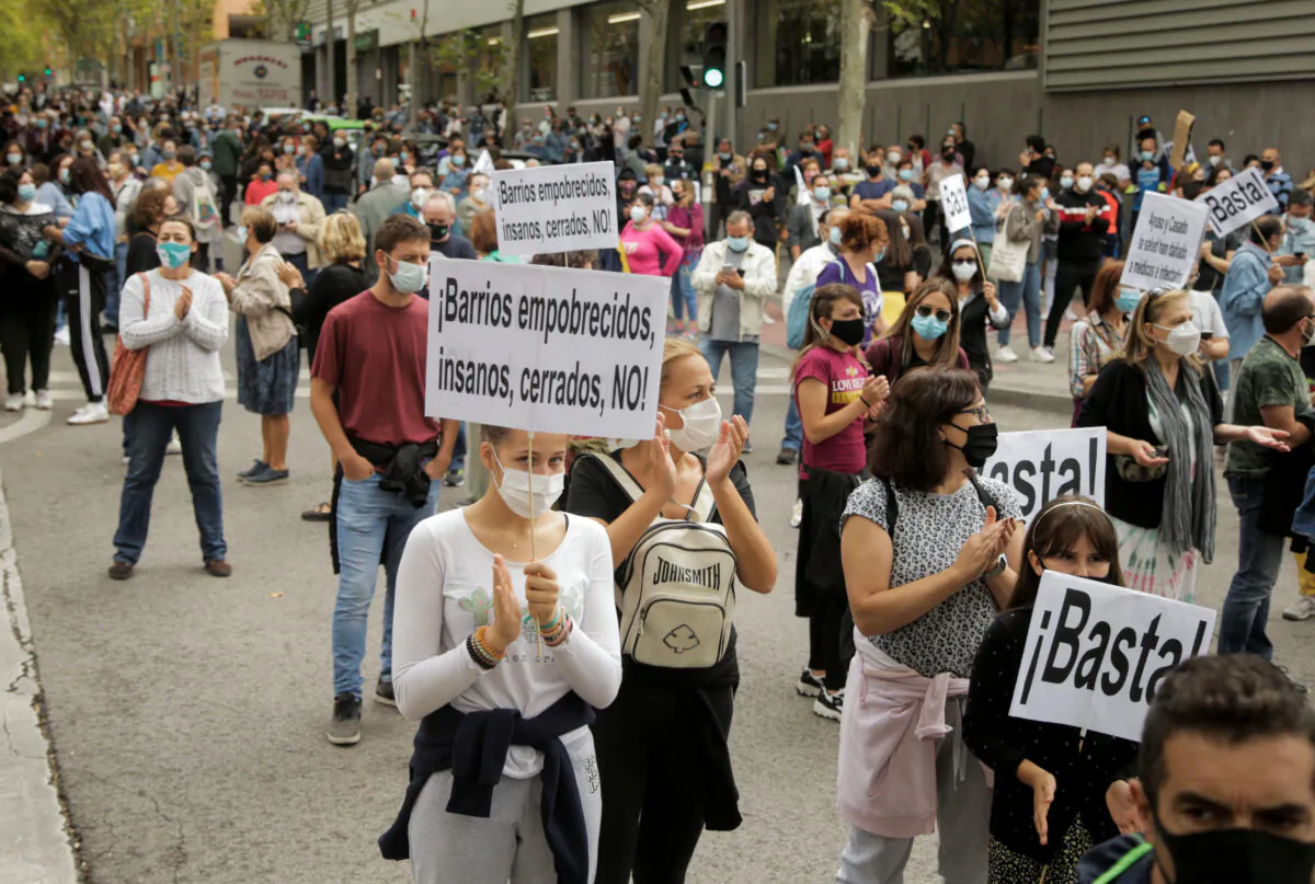 People protest in front of the Madrid regional government's health office over the lack of support and movement on improving working conditions at the Vallecas neighborhood, amid the outbreak of the coronavirus disease (COVID-19) in Madrid, Spain, on Sept. 20, 2020. (Javier Barbancho/Reuters)