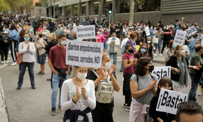People protest in front of the Madrid regional government's health office over the lack of support and movement on improving working conditions at the Vallecas neighborhood, amid the outbreak of the coronavirus disease (COVID-19) in Madrid, Spain, on Sept. 20, 2020. (Javier Barbancho/Reuters)