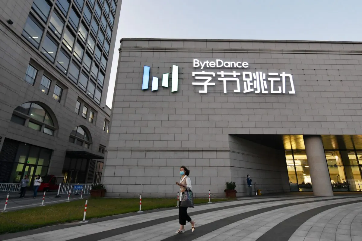 A woman walks past a building belonging to ByteDance, the parent company of video-sharing app TikTok, in Beijing on Sept. 16, 2020. (Greg Baker/AFP via Getty Images)