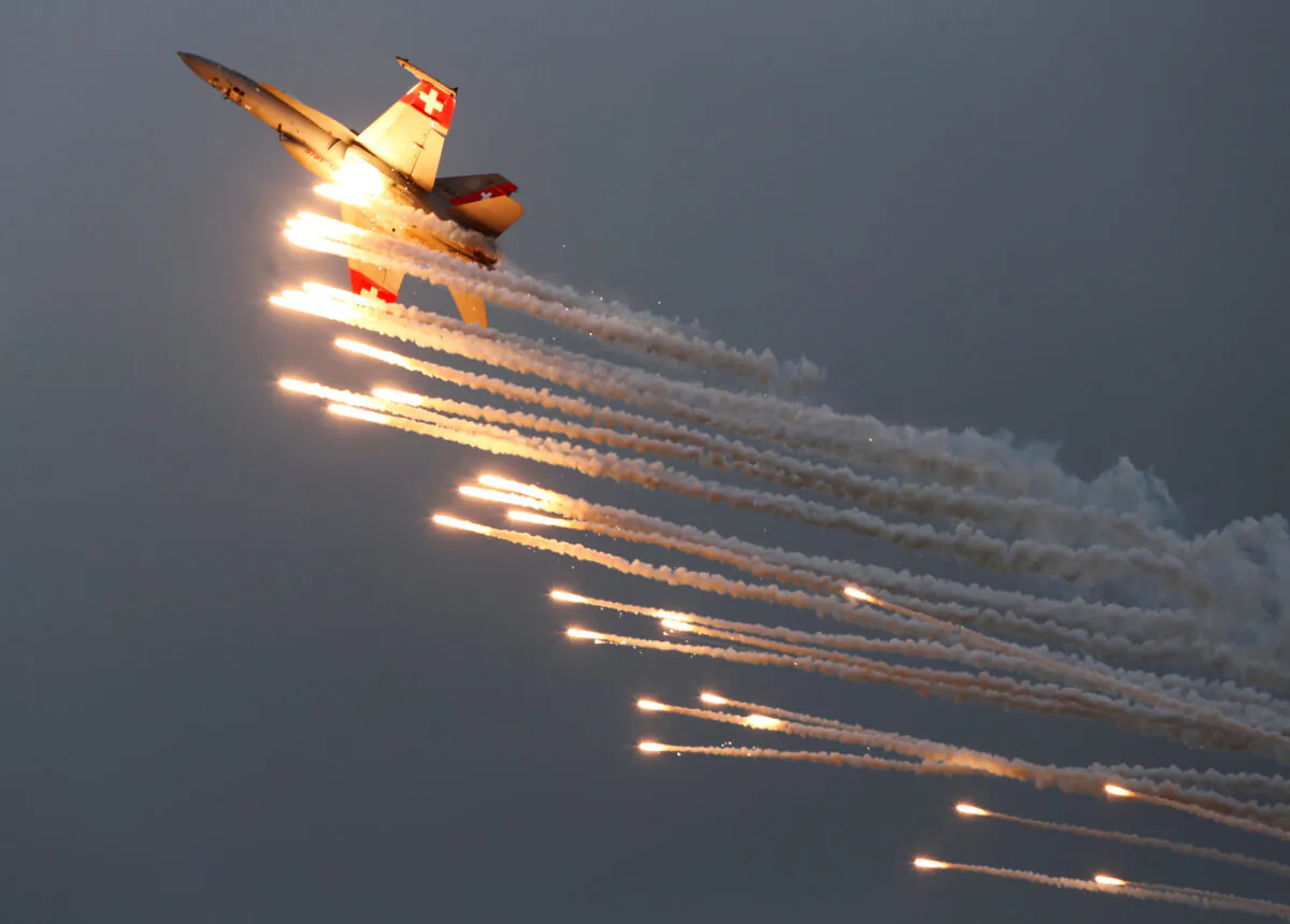 A Swiss Air Force F/A 18 Hornet aircraft releases flare during the Air14 airshow at the airport in Payerne, Switzerland, on Aug. 31, 2014. (Denis Balibouse/Reuters)