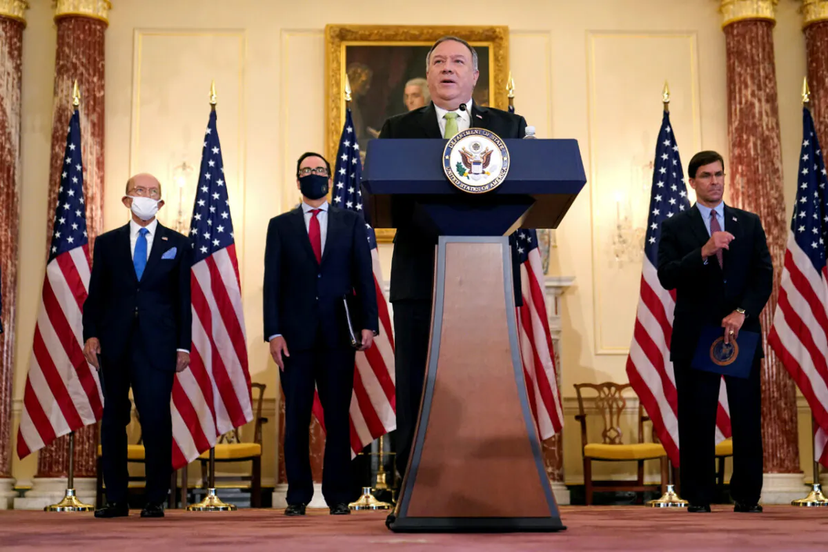 U.S. Secretary of State Mike Pompeo speaks next to Commerce Secretary Wilbur Ross, Treasury Secretary Steve Mnuchin, and Defense Secretary Mark Esper, during a news conference to announce the Trump administration's restoration of sanctions on Iran, at the U.S. State Department in Washington, U.S., Sept. 21, 2020. (Patrick Semansky/Pool via Reuters)
