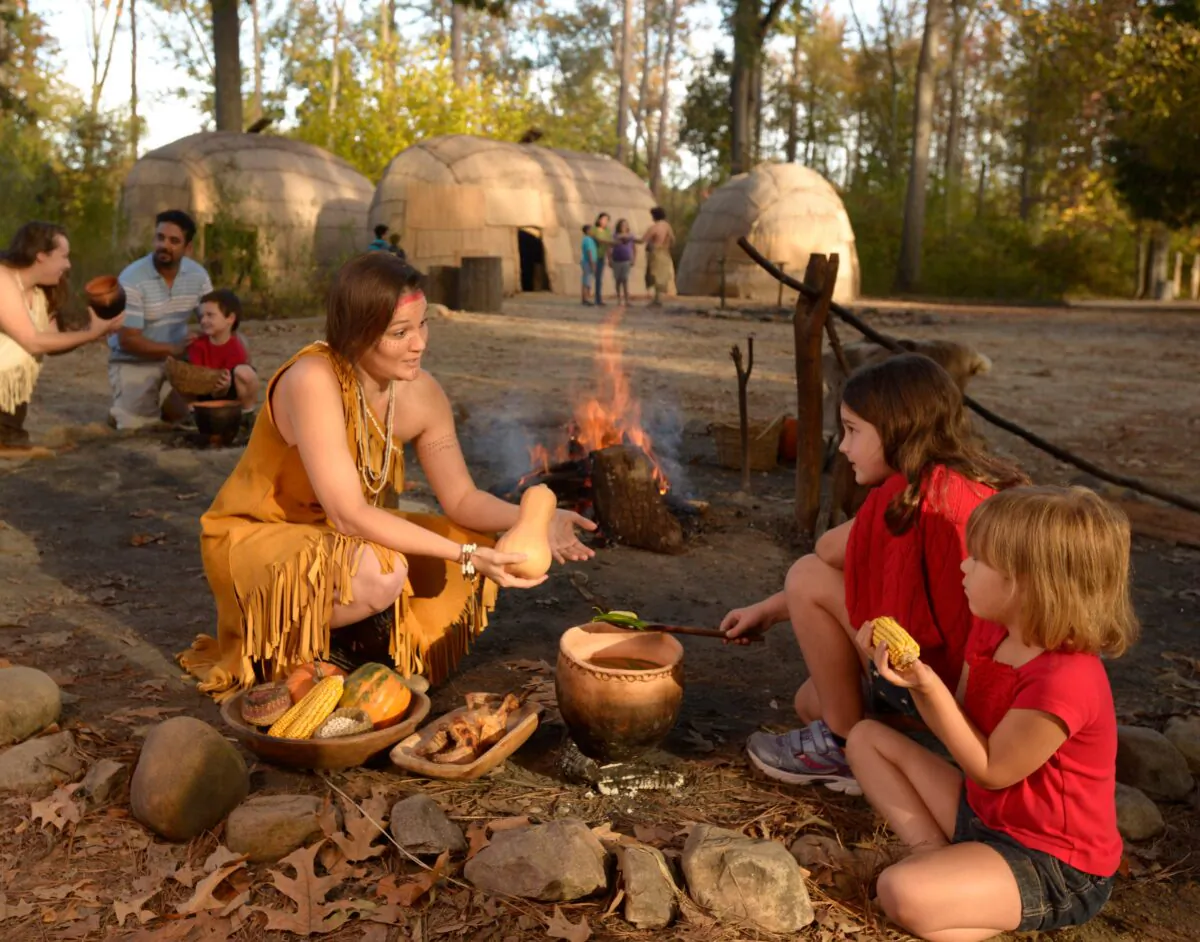 Young visitors enjoy the Powhatan Indian Village, which is based on archaeological findings, at the Jamestown Settlement. (Jamestown-Yorktown Foundation)