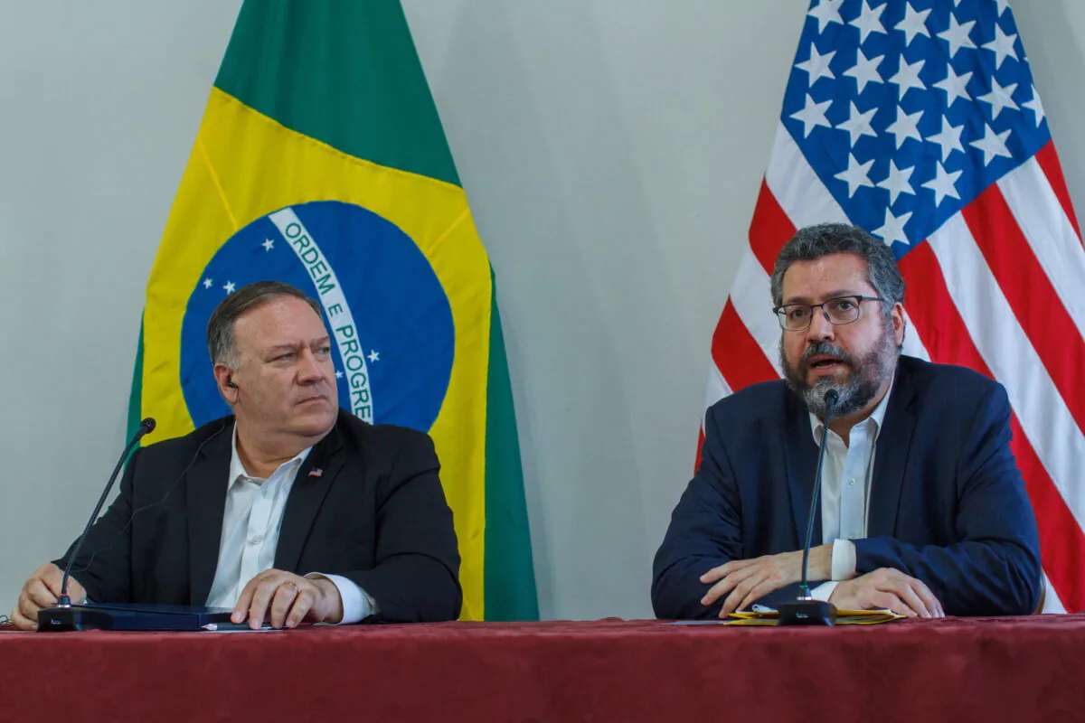 U.S. Secretary of State Mike Pompeo looks at Brazilian Foreign Minister Ernesto Araujo speaking during a press conference at the Boa Vista Air Base in Roraima, Brazil, on Sept. 18, 2020. (Bruno Mancinelle/Pool via AP)