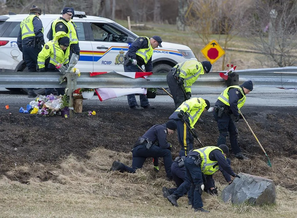 RCMP investigators search for evidence at the location where Const. Heidi Stevenson was killed along the highway in Shubenacadie, N.S., on April 23, 2020. (The Canadian Press/Andrew Vaughan)