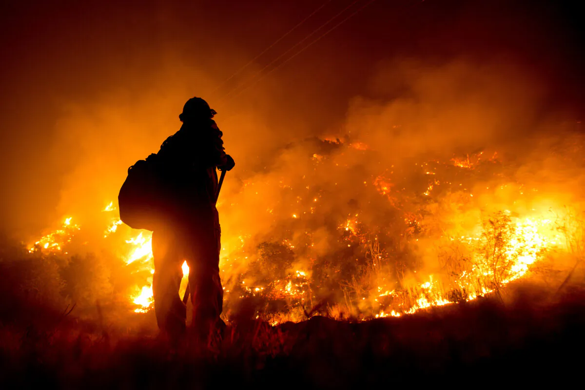 A firefighter works at the scene of the Bobcat Fire burning on hillsides near Monrovia Canyon Park in Monrovia, Calif., on Sept. 15, 2020. (Ringo Chiu / AFP via Getty Images)