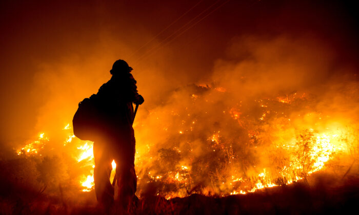 A firefighter works at the scene of the Bobcat Fire burning on hillsides near Monrovia Canyon Park in Monrovia, Calif., on Sept. 15, 2020. (Ringo Chiu / AFP via Getty Images)