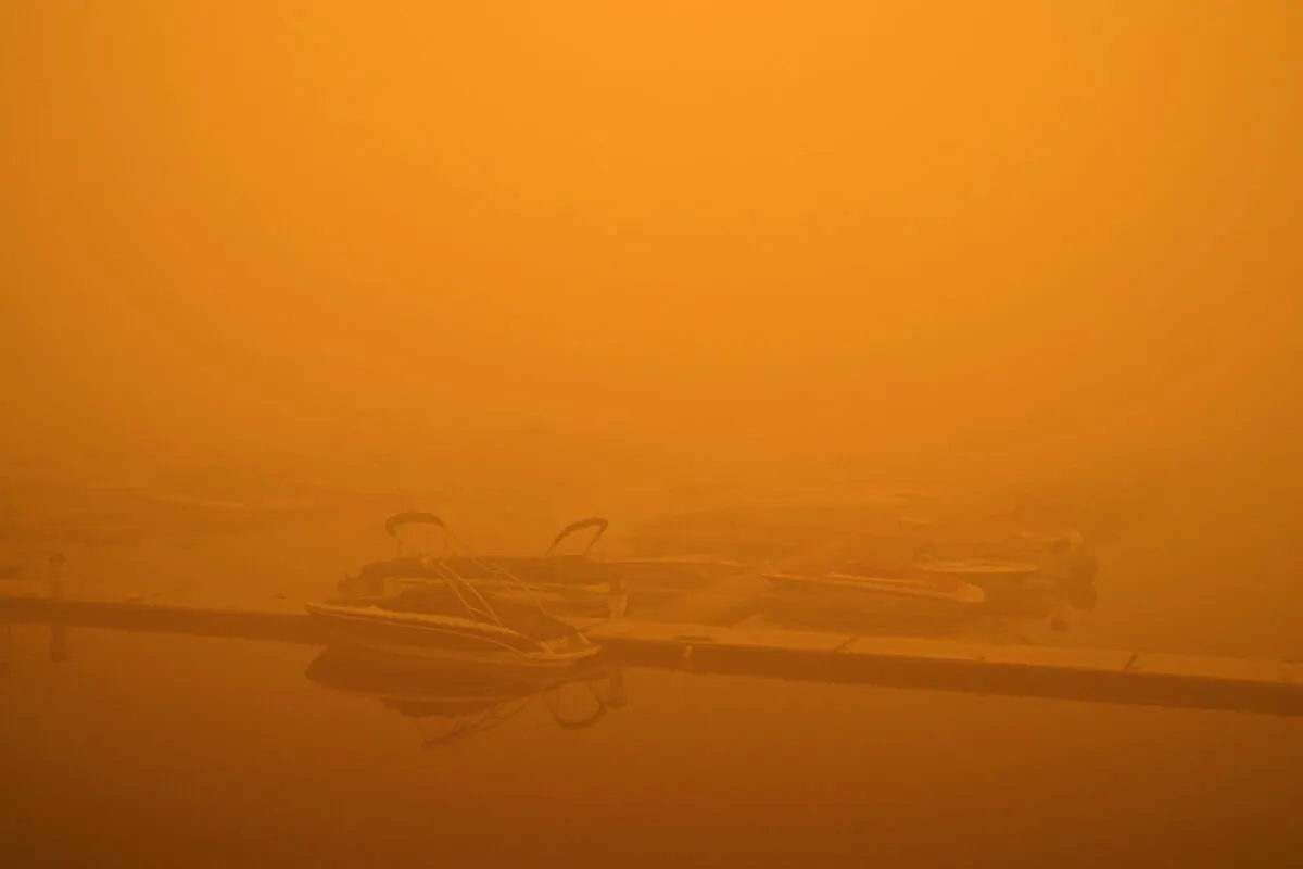 Boats are partially obscured by smoke from a wildfire at a marina on Detroit Lake burned by the Beachie Creek Fire in Detroit, Ore., Sept. 12, 2020. (John Locher/AP Photo)
