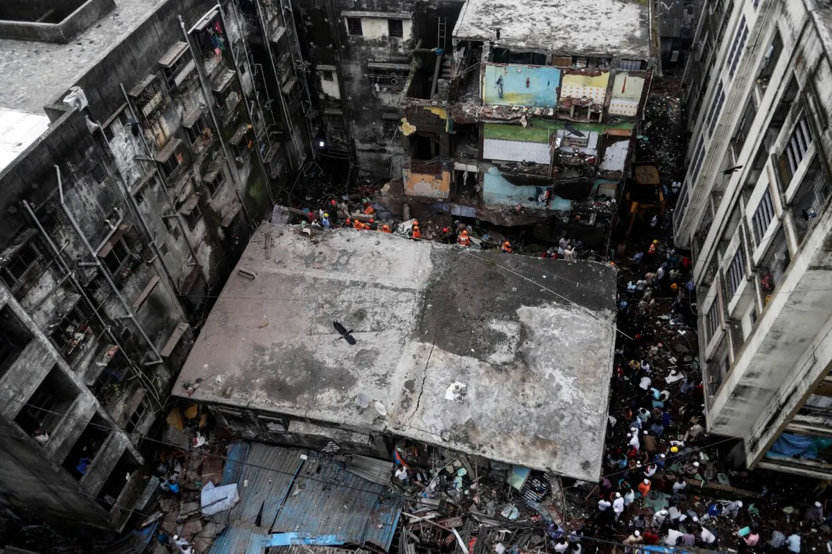 Rescue workers search for survivors from the debris after a three-storey residential building collapsed in Bhiwandi on the outskirts of Mumbai, India, on Sept. 21, 2020. (Francis Mascarenhas/Reuters)