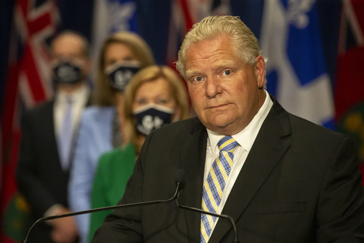 Ontario Premier Doug Ford stands in front of a selection of his cabinet ministers during a joint press conference with Quebec Premier Francois Legault at the Ontario-Quebec Summit, in Toronto on Sept. 9, 2020. (The Canadian Press/Chris Young)