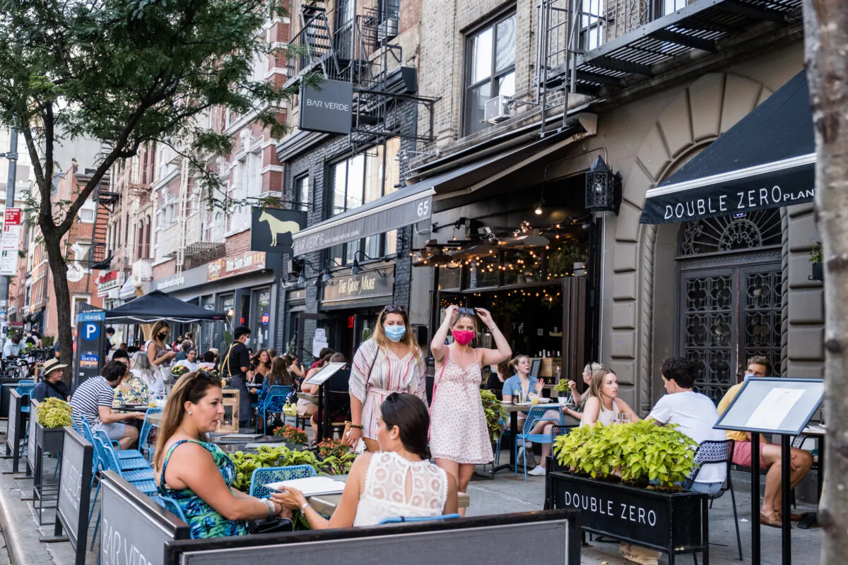 People dine al fresco, or in the open air, in the East Village in New York City, on July 21, 2020. (Jeenah Moon/Getty Images)