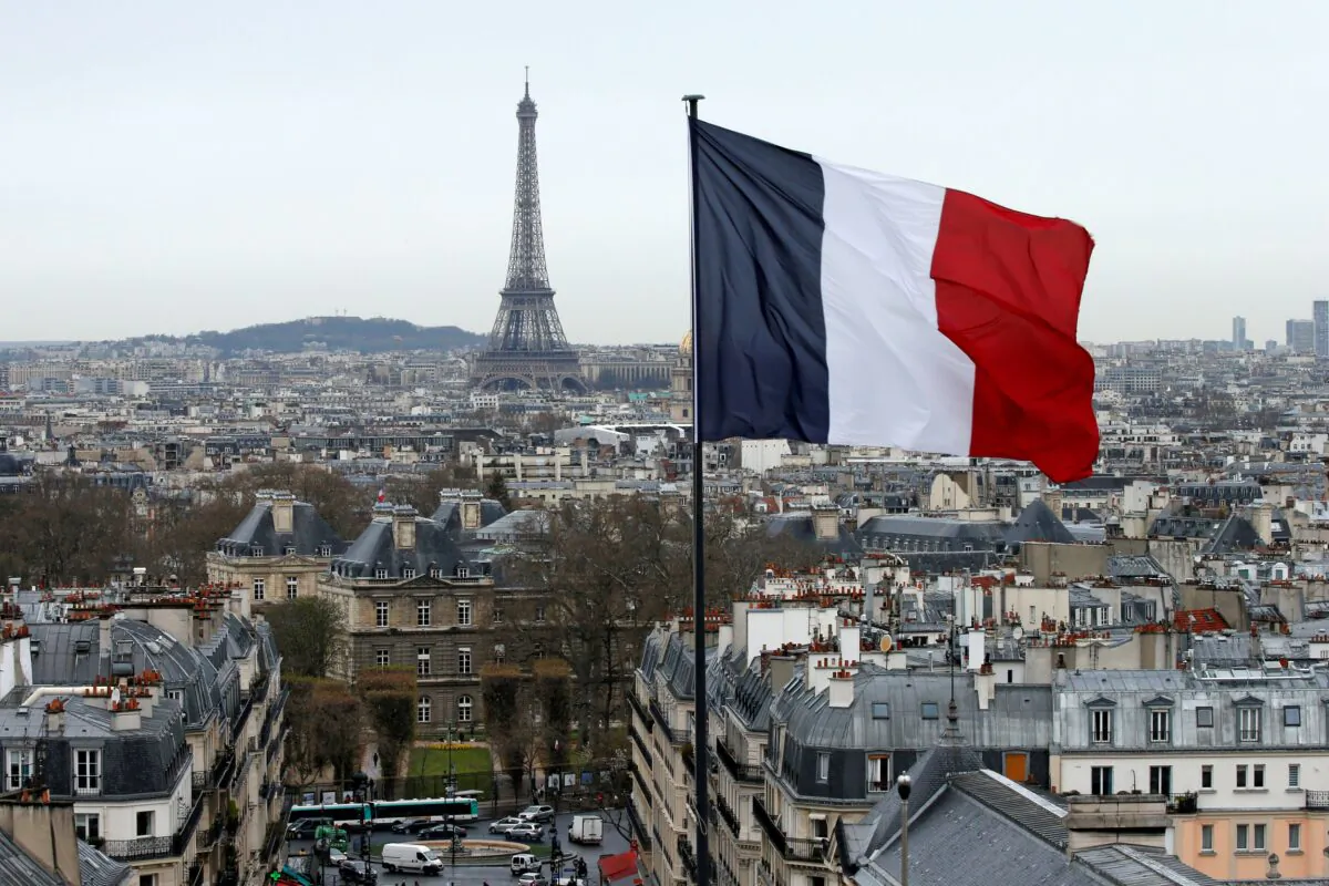 A city view shows the French flag above the skyline of the French capital as the Eiffel Tower and roof tops are seen in Paris, France, on March 30, 2016. (Benoit Tessier/Reuters)